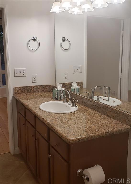 366 Forward Street, Unit E La Jolla, CA 92037 - Photo 9 of 26 a bathroom with a granite countertop sink and a mirror