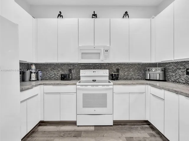 a view of a hallway with entryway and stairs