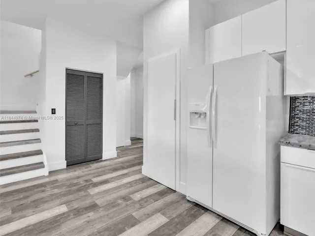 a living room with furniture and view of kitchen