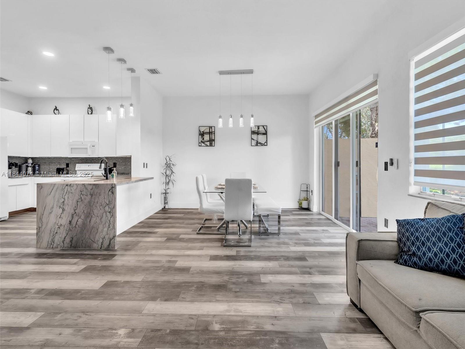 4331 Southwest 124th Way Miramar, FL 33027 - Photo 17 of 58 a living room with furniture and view of kitchen