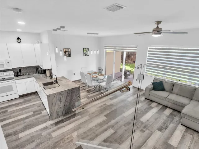 a bathroom with a sink toilet vanity and shower