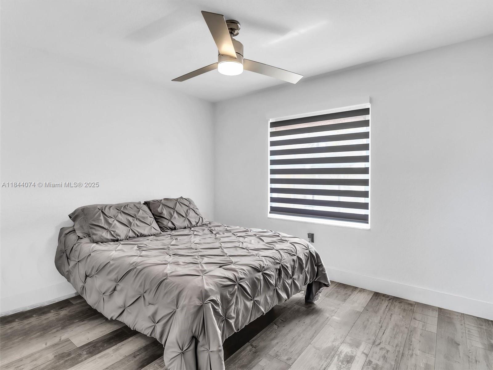 4331 Southwest 124th Way Miramar, FL 33027 - Photo 29 of 58 a bedroom with a bed and a window