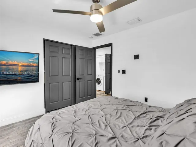 a bedroom with a bed and a flat screen tv