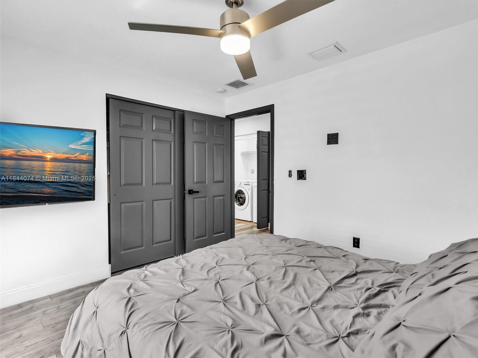 4331 Southwest 124th Way Miramar, FL 33027 - Photo 30 of 58 a bedroom with a bed and a flat screen tv