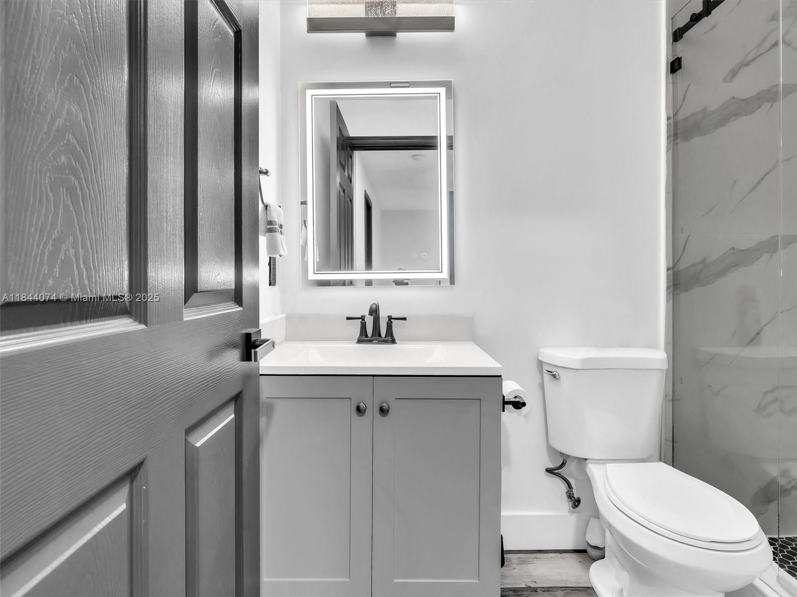 4331 Southwest 124th Way Miramar, FL 33027 - Photo 32 of 58 a bathroom with a toilet a sink a mirror and vanity