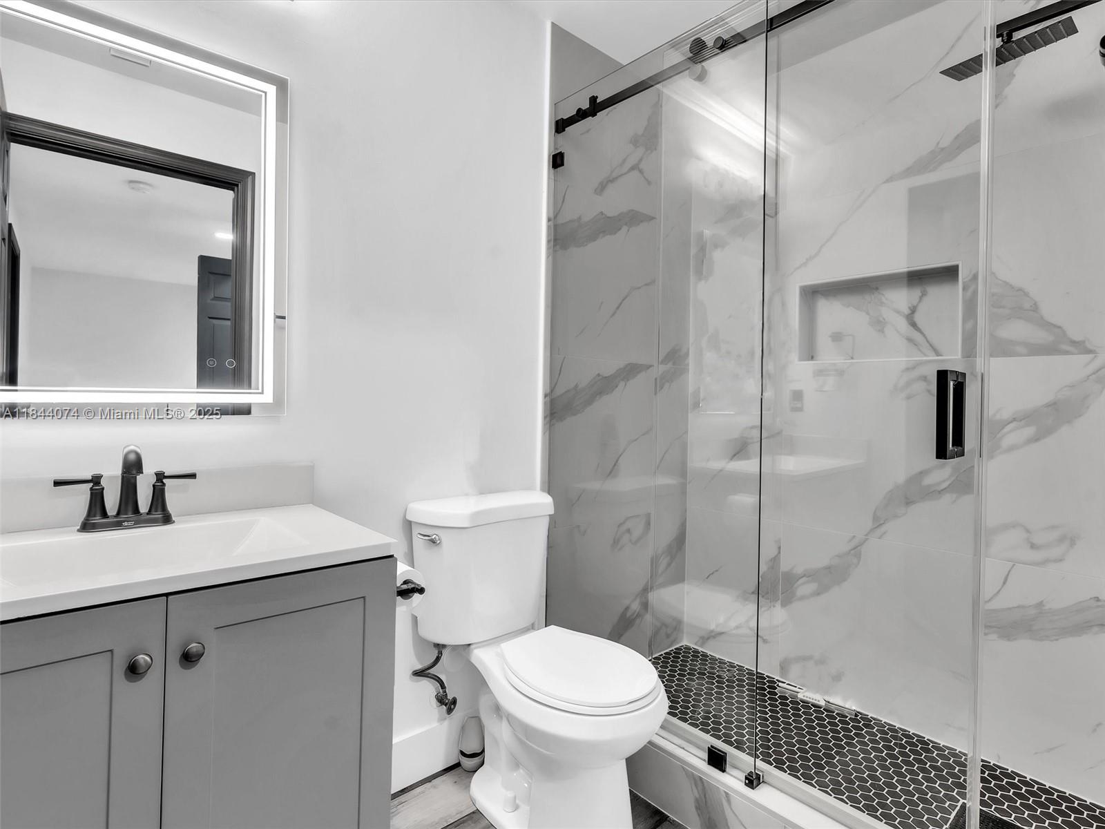 4331 Southwest 124th Way Miramar, FL 33027 - Photo 33 of 58 a bathroom with a sink toilet vanity and shower