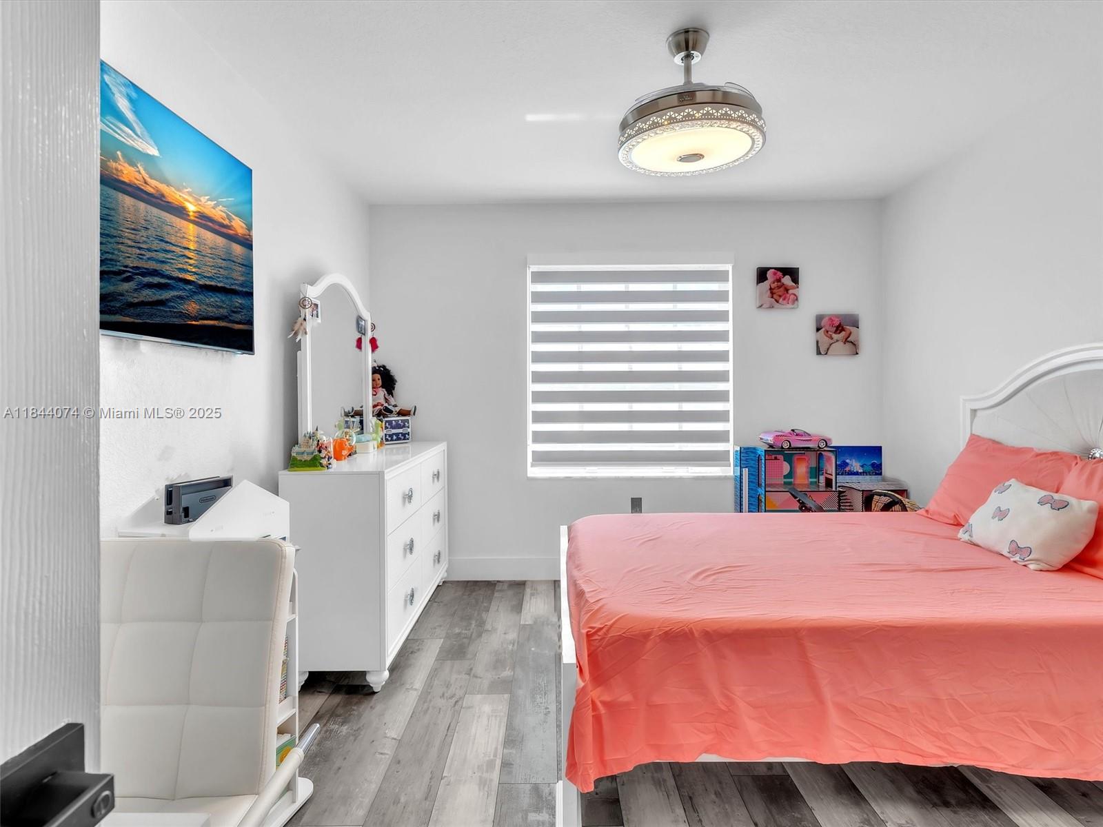 4331 Southwest 124th Way Miramar, FL 33027 - Photo 34 of 58 a bedroom with a bed and a flat screen tv