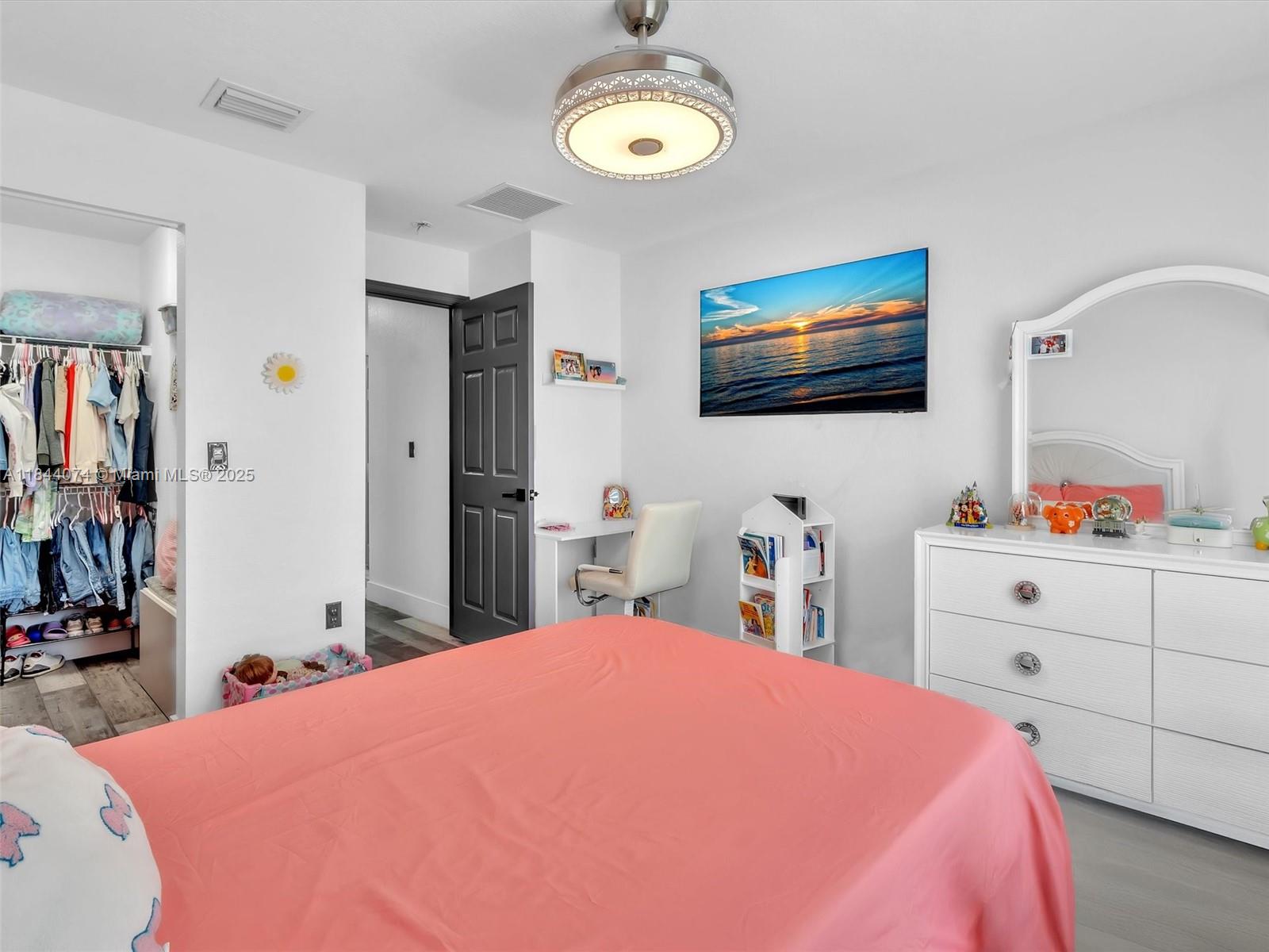 4331 Southwest 124th Way Miramar, FL 33027 - Photo 35 of 58 a bedroom with a bed and a flat screen tv