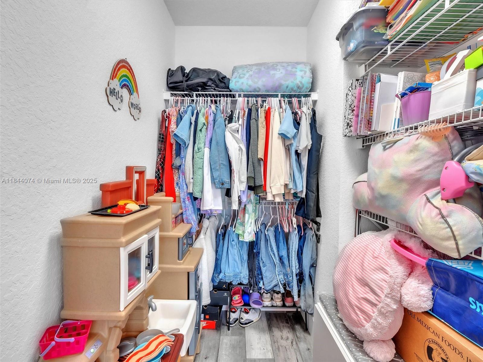 4331 Southwest 124th Way Miramar, FL 33027 - Photo 36 of 58 a view of walk in closet with clothes and shoes