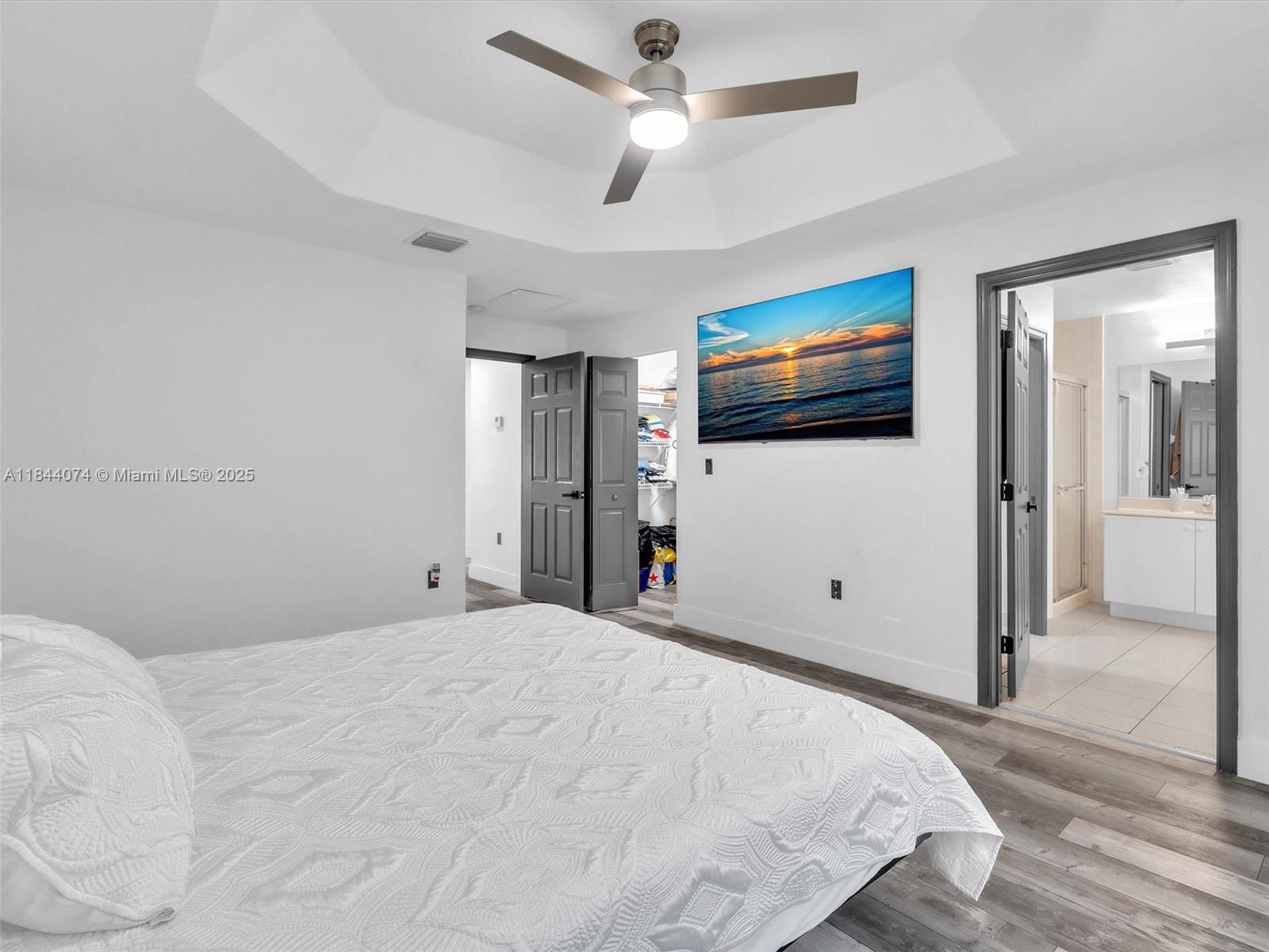 4331 Southwest 124th Way Miramar, FL 33027 - Photo 38 of 58 a bedroom with a bed and a flat screen tv