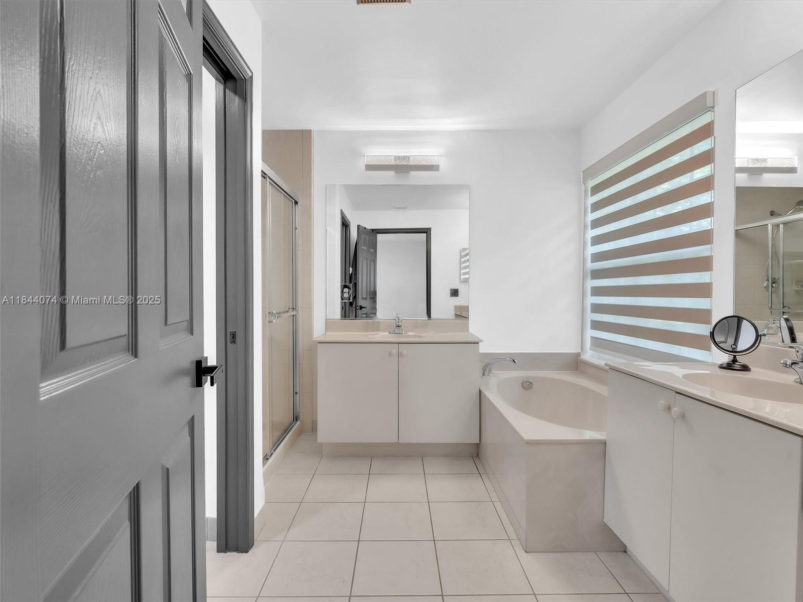 4331 Southwest 124th Way Miramar, FL 33027 - Photo 39 of 58 a bathroom with a tub sink and mirror