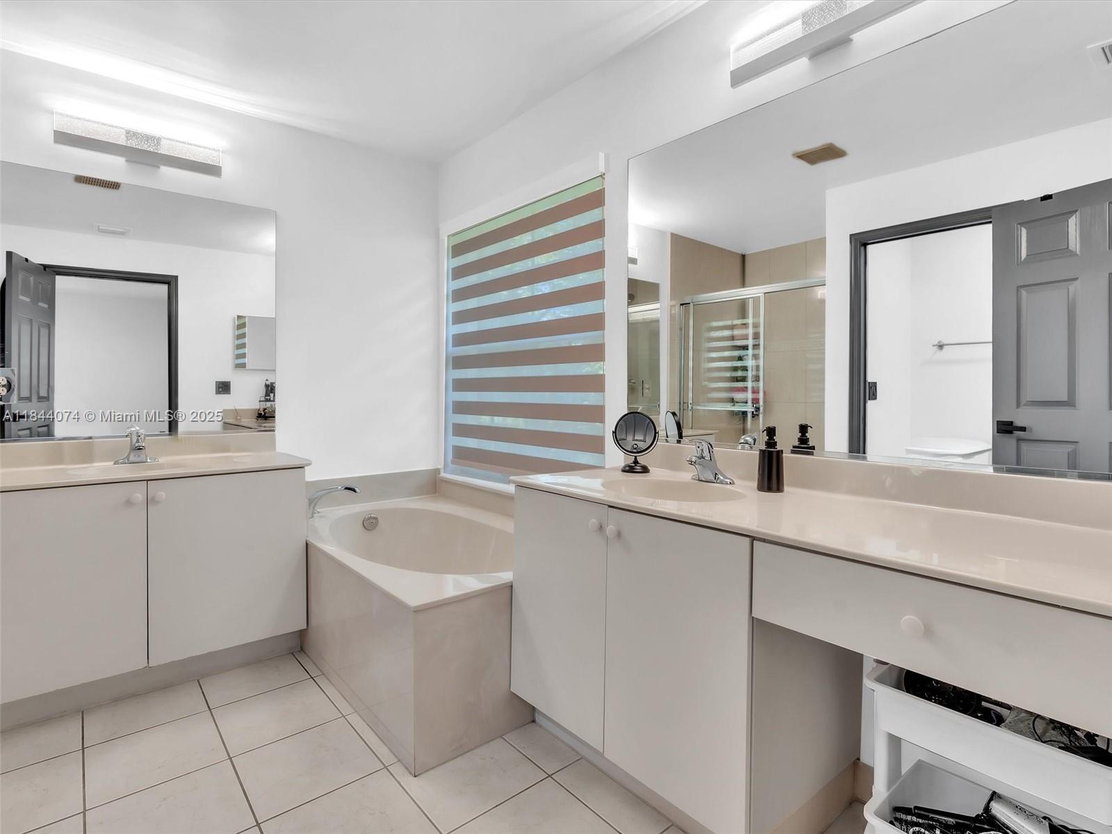 4331 Southwest 124th Way Miramar, FL 33027 - Photo 40 of 58 a bathroom with a sink mirror and a bathtub