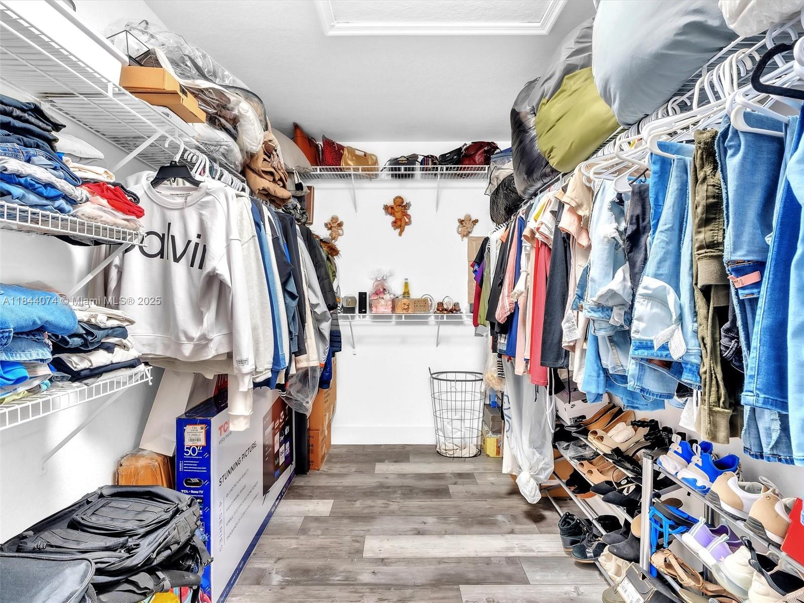 4331 Southwest 124th Way Miramar, FL 33027 - Photo 42 of 58 a view of walk in closet with clothes and shoes