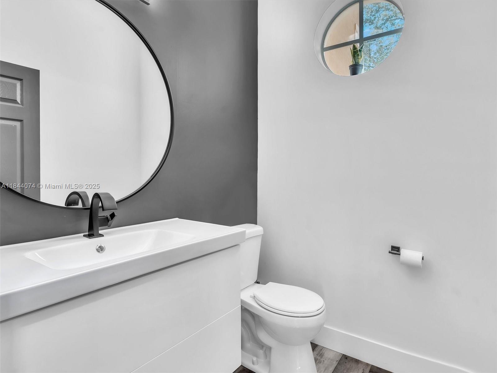 4331 Southwest 124th Way Miramar, FL 33027 - Photo 6 of 58 a bathroom with a sink and mirror