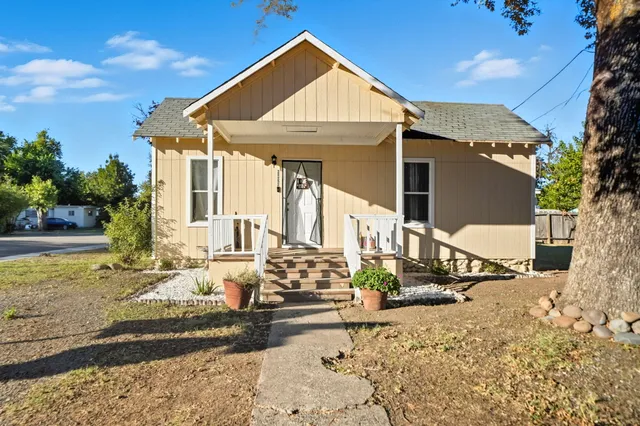 a view of a house with snow on the road