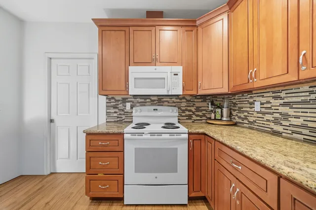 a stove top oven sitting inside of a kitchen