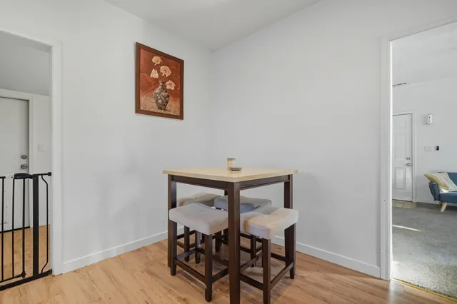 a view of a room with furniture and wooden floor