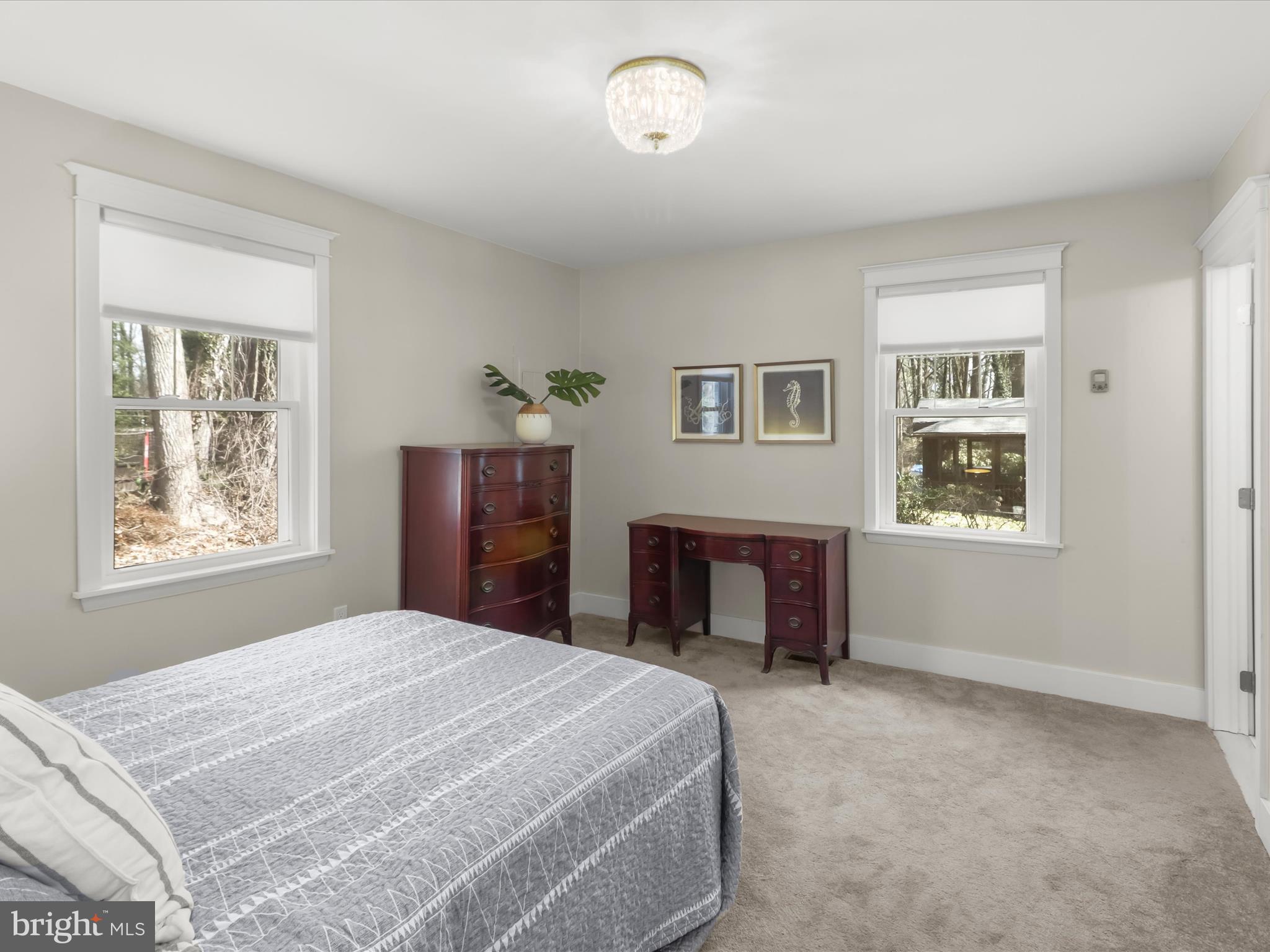 941 Buttonwood Trail Crownsville, MD 21032 - Photo 14 of 43 a bedroom with a bed and a dresser next to a window