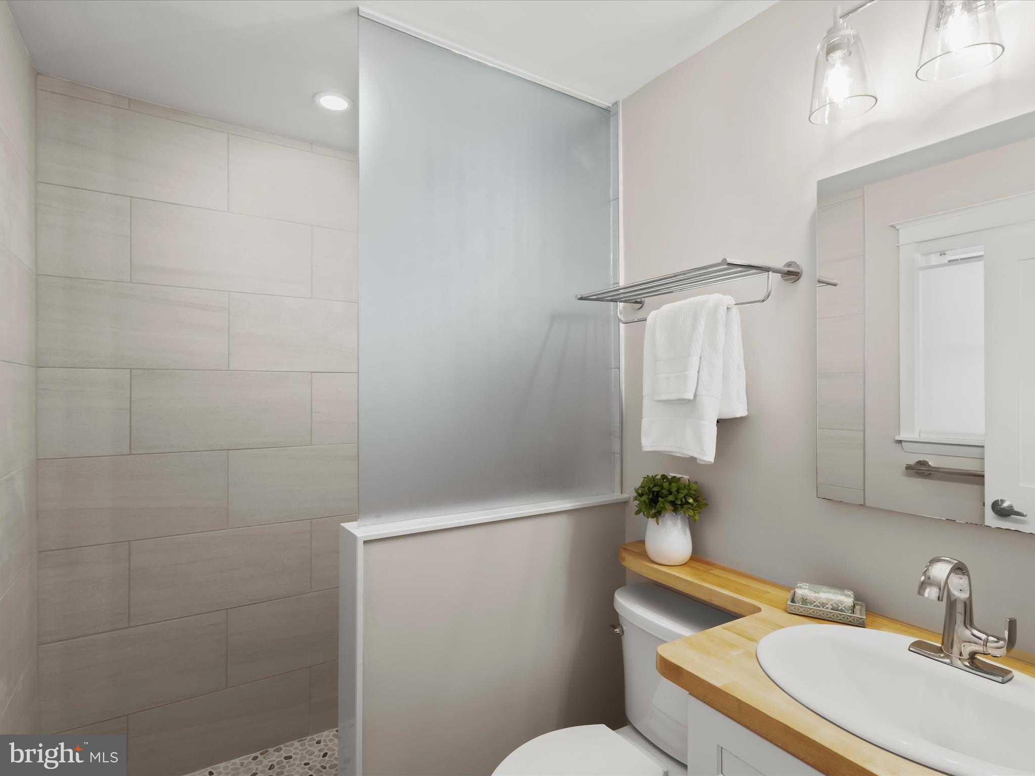 941 Buttonwood Trail Crownsville, MD 21032 - Photo 16 of 43 a bathroom with a sink a toilet and shower