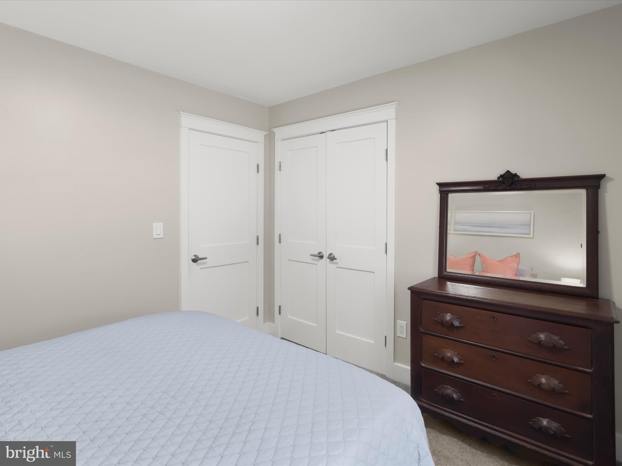 941 Buttonwood Trail Crownsville, MD 21032 - Photo 21 of 43 a bedroom with a bed and a mirror on dresser