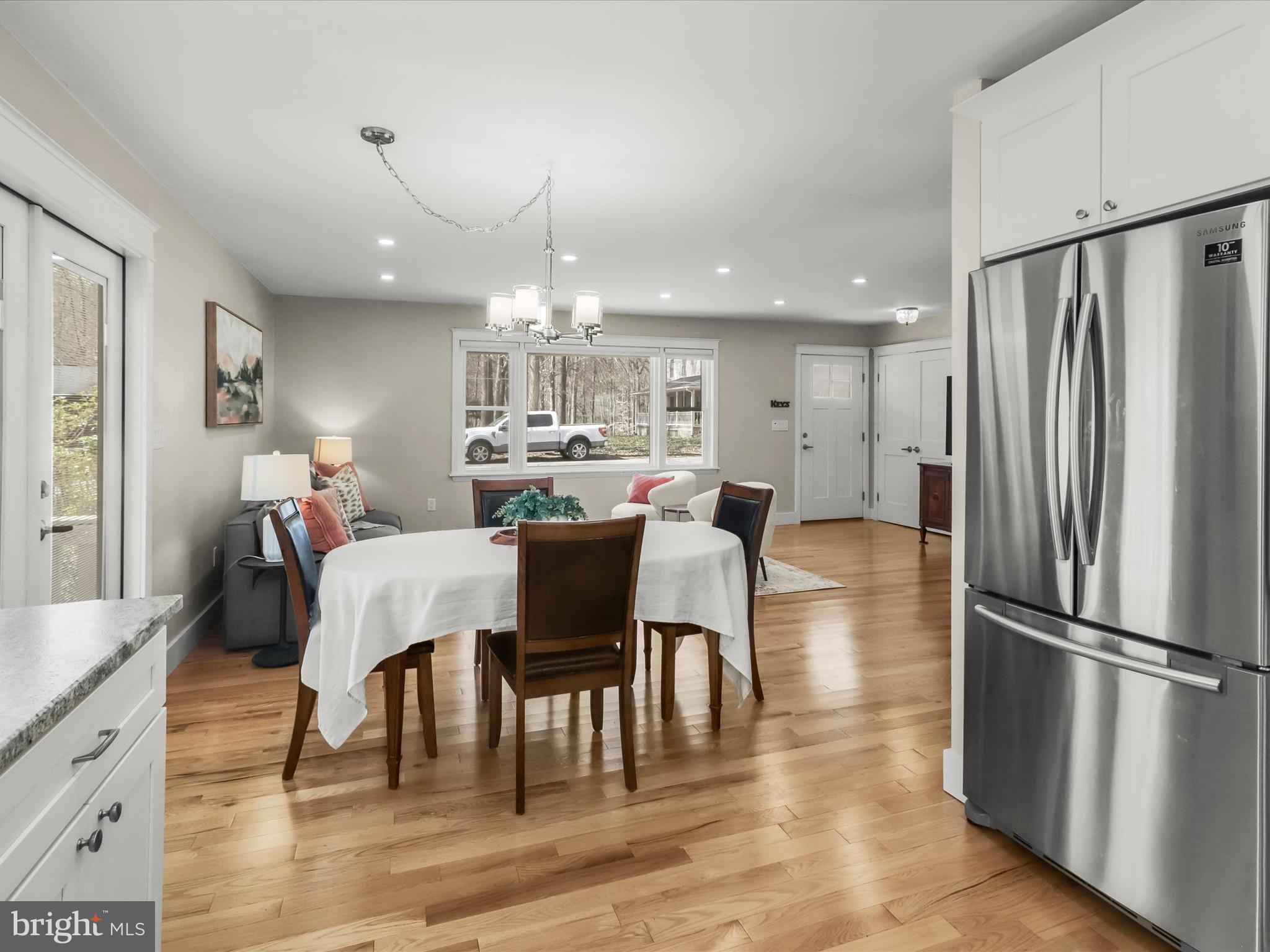 941 Buttonwood Trail Crownsville, MD 21032 - Photo 5 of 43 a kitchen with stainless steel appliances granite countertop a dining table chairs refrigerator sink and cabinets