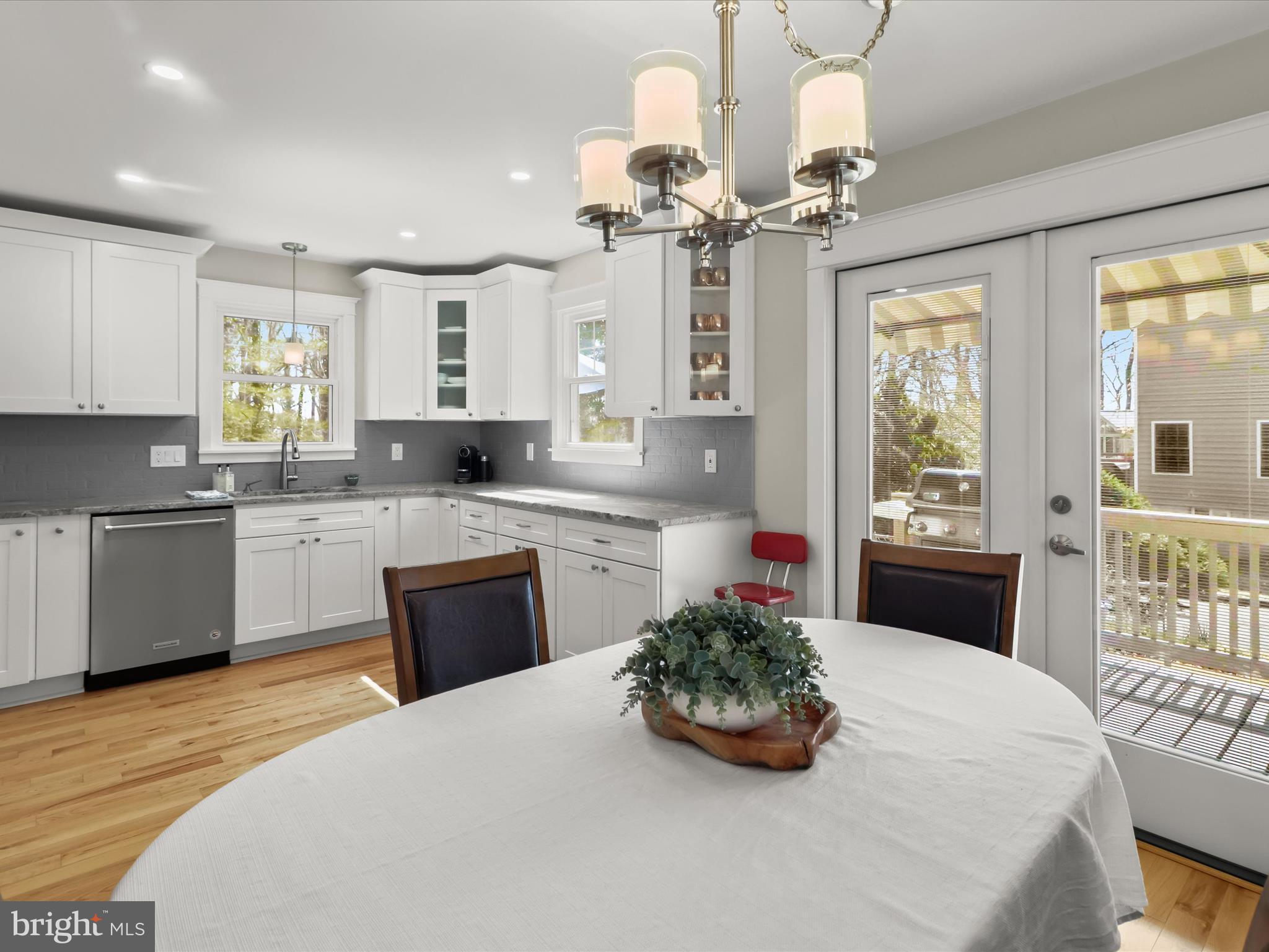 941 Buttonwood Trail Crownsville, MD 21032 - Photo 6 of 43 a kitchen with stainless steel appliances a large counter top a stove a chimney a sink and cabinets