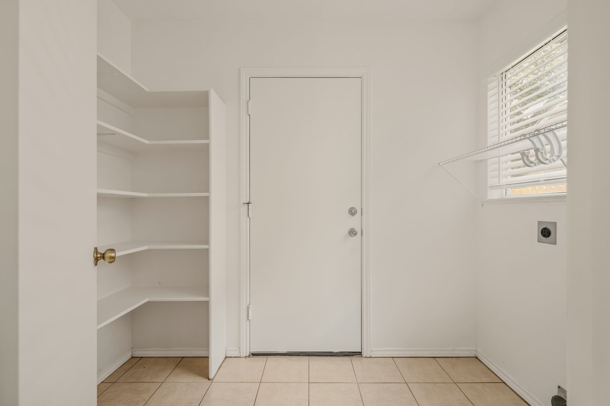 1408 Water Spaniel Way Round Rock, TX 78664 - Photo 34 of 37 Functional laundry space featuring ample shelving and durable tiled flooring.