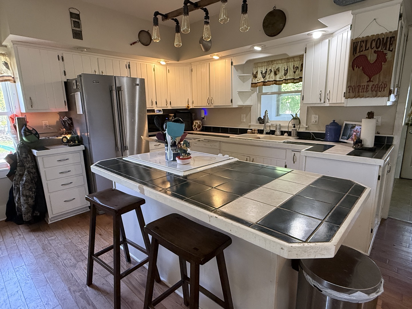 22503 2800th Road North Odell, IL 60460 - Photo 5 of 30 a kitchen with stainless steel appliances granite countertop a stove a refrigerator a sink a dining table and chairs with wooden floor