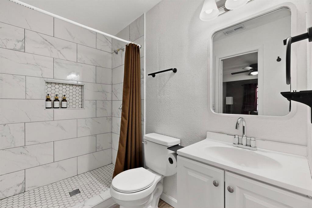 10834 Cassandra Way Dallas, TX 75228 - Photo 12 of 20 a bathroom with a sink toilet and shower