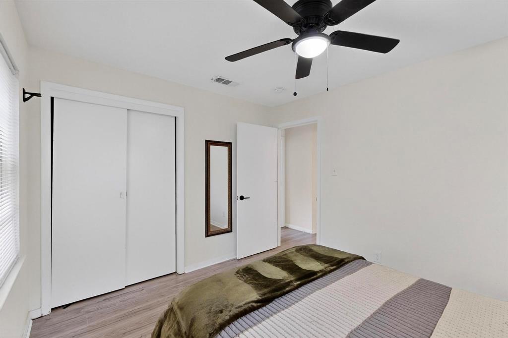 10834 Cassandra Way Dallas, TX 75228 - Photo 14 of 20 a bedroom with a bed and a chandelier