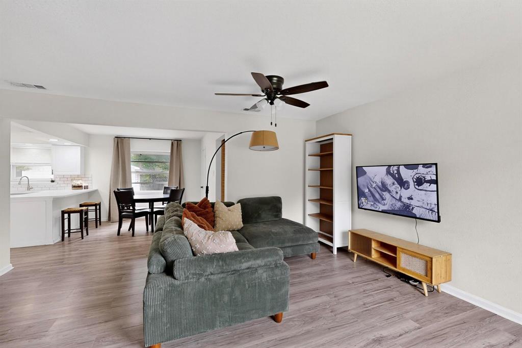 10834 Cassandra Way Dallas, TX 75228 - Photo 4 of 20 a living room with furniture wooden floor and a chandelier