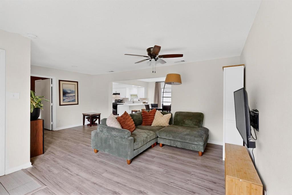 10834 Cassandra Way Dallas, TX 75228 - Photo 5 of 20 a living room with furniture and a flat screen tv