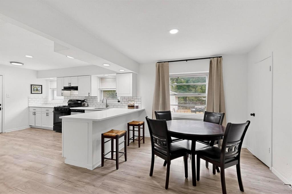 10834 Cassandra Way Dallas, TX 75228 - Photo 7 of 20 a kitchen with a dining table chairs and wooden floor
