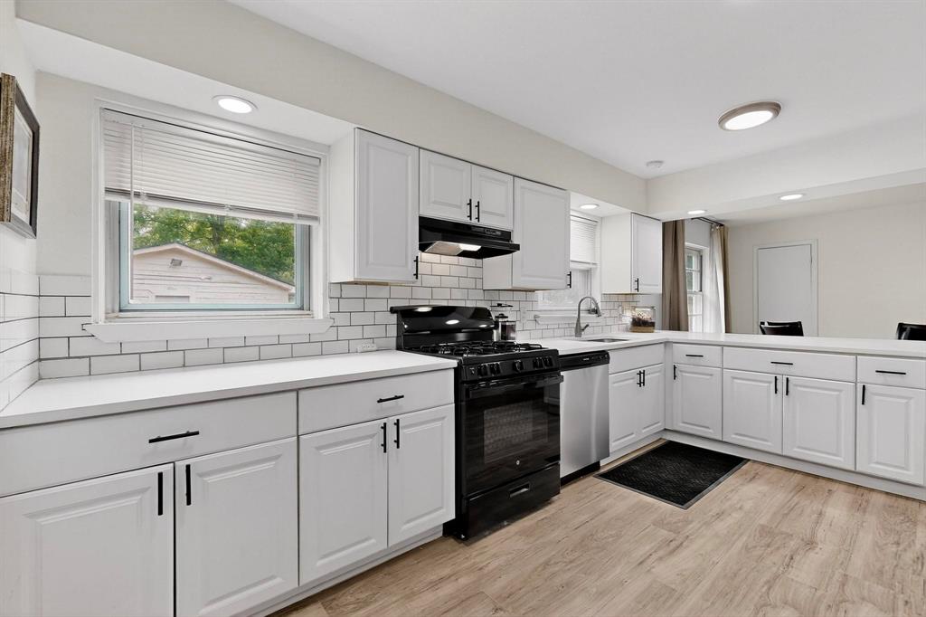 10834 Cassandra Way Dallas, TX 75228 - Photo 8 of 20 a kitchen with granite countertop white cabinets and a stove