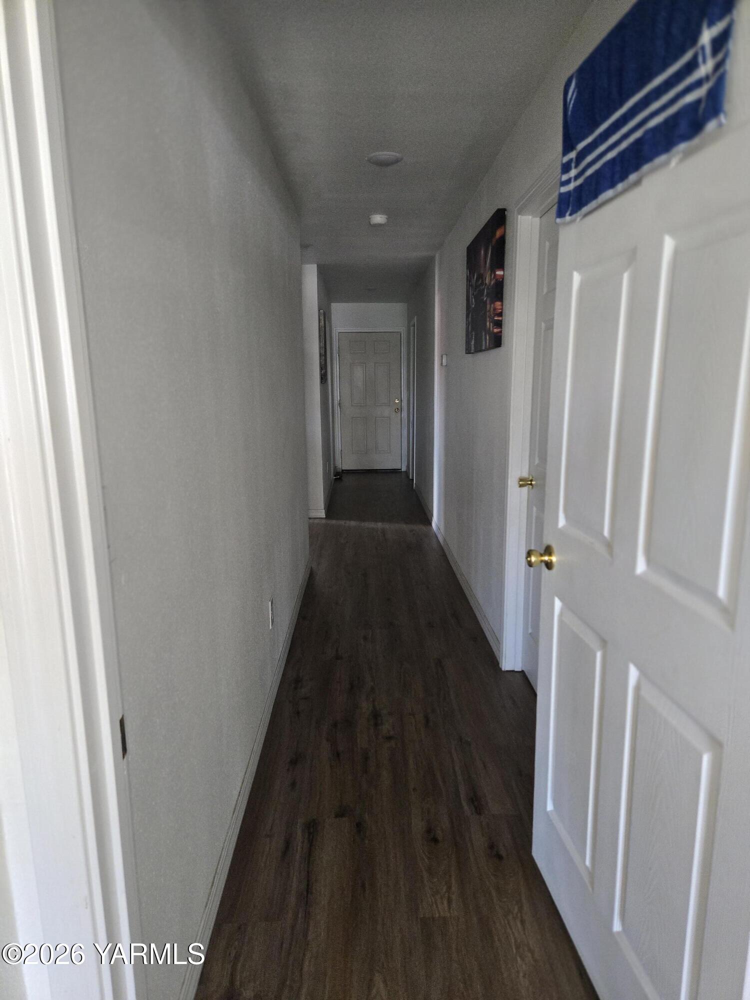 208 North Chestnut Street Toppenish, WA 98948 - Photo 6 of 10 a view of a hallway with wooden floor and staircase