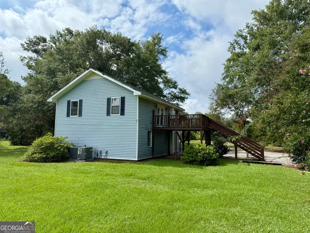 a view of a house with a yard and plants