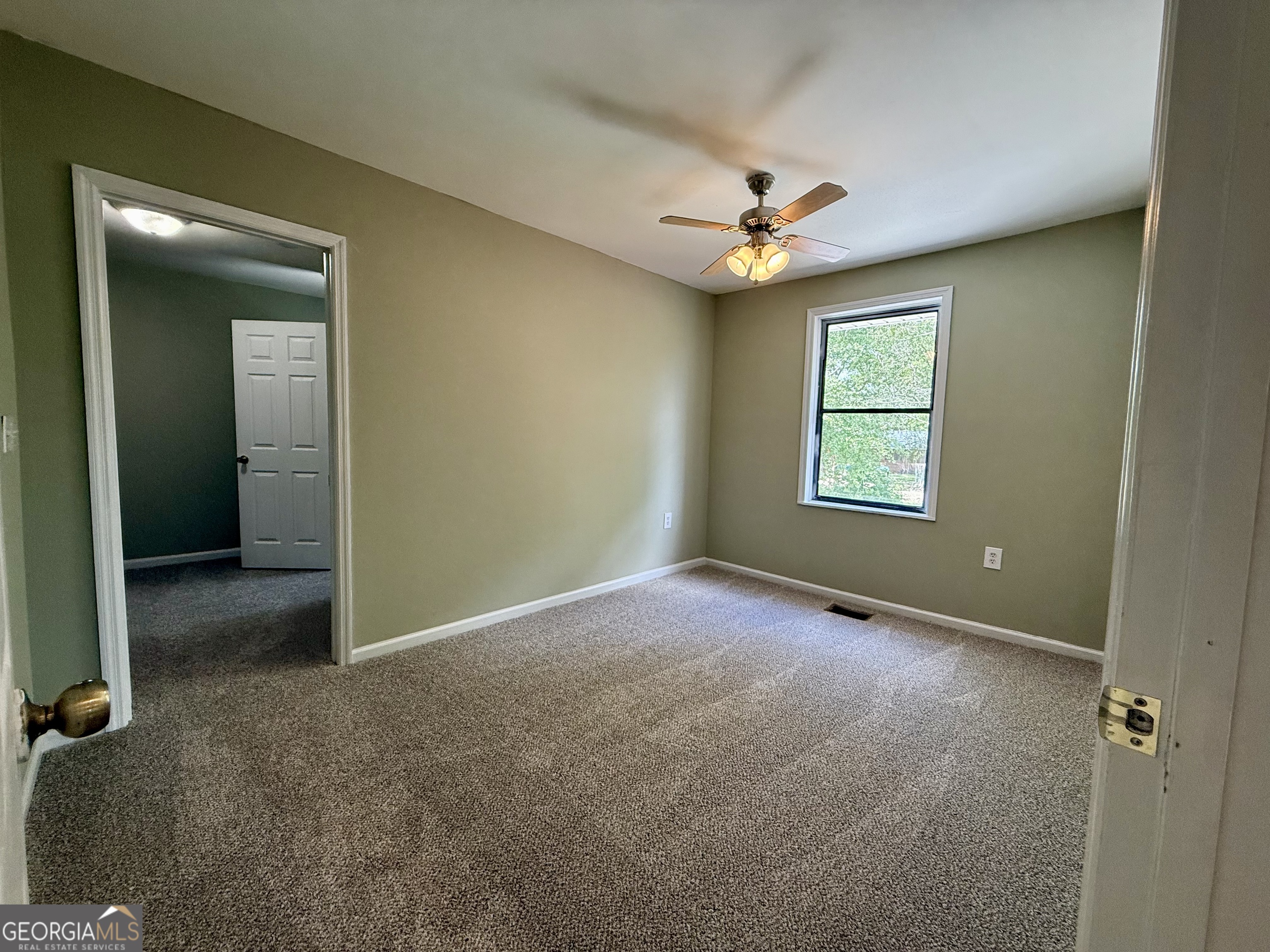2592 White Oak Road Thomson, GA 30824 - Photo 12 of 30 an empty room with windows and fan