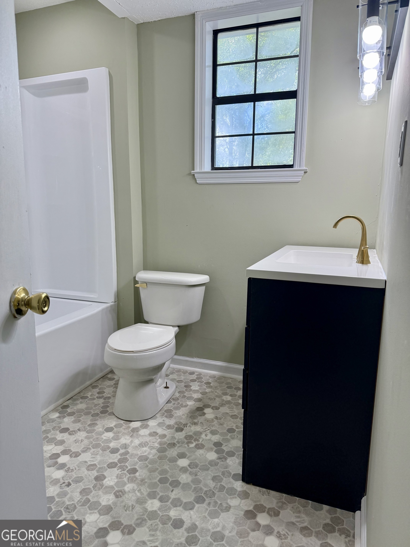 2592 White Oak Road Thomson, GA 30824 - Photo 22 of 30 a bathroom with a sink toilet and window