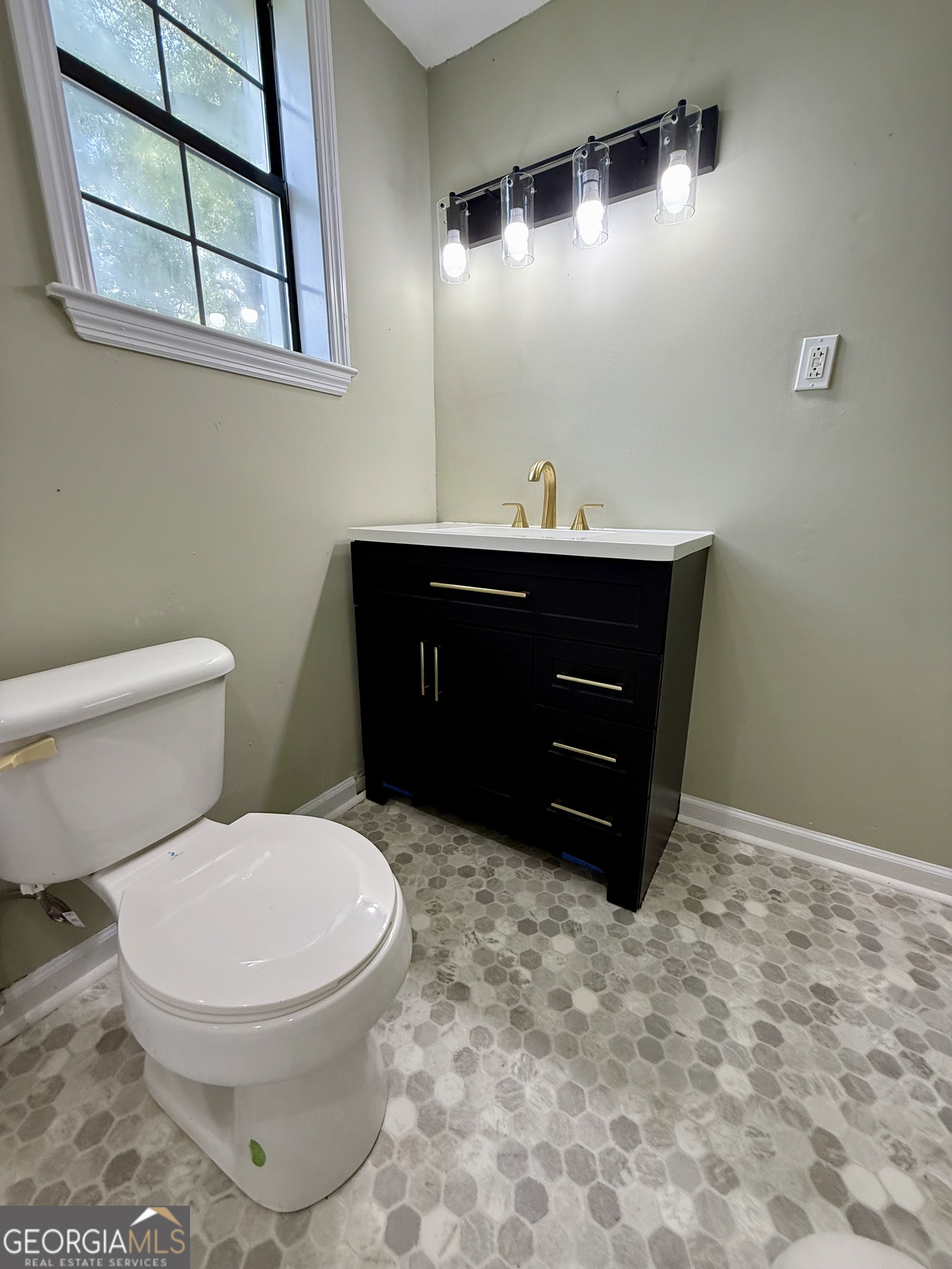 2592 White Oak Road Thomson, GA 30824 - Photo 24 of 30 a bathroom with a toilet sink and mirror