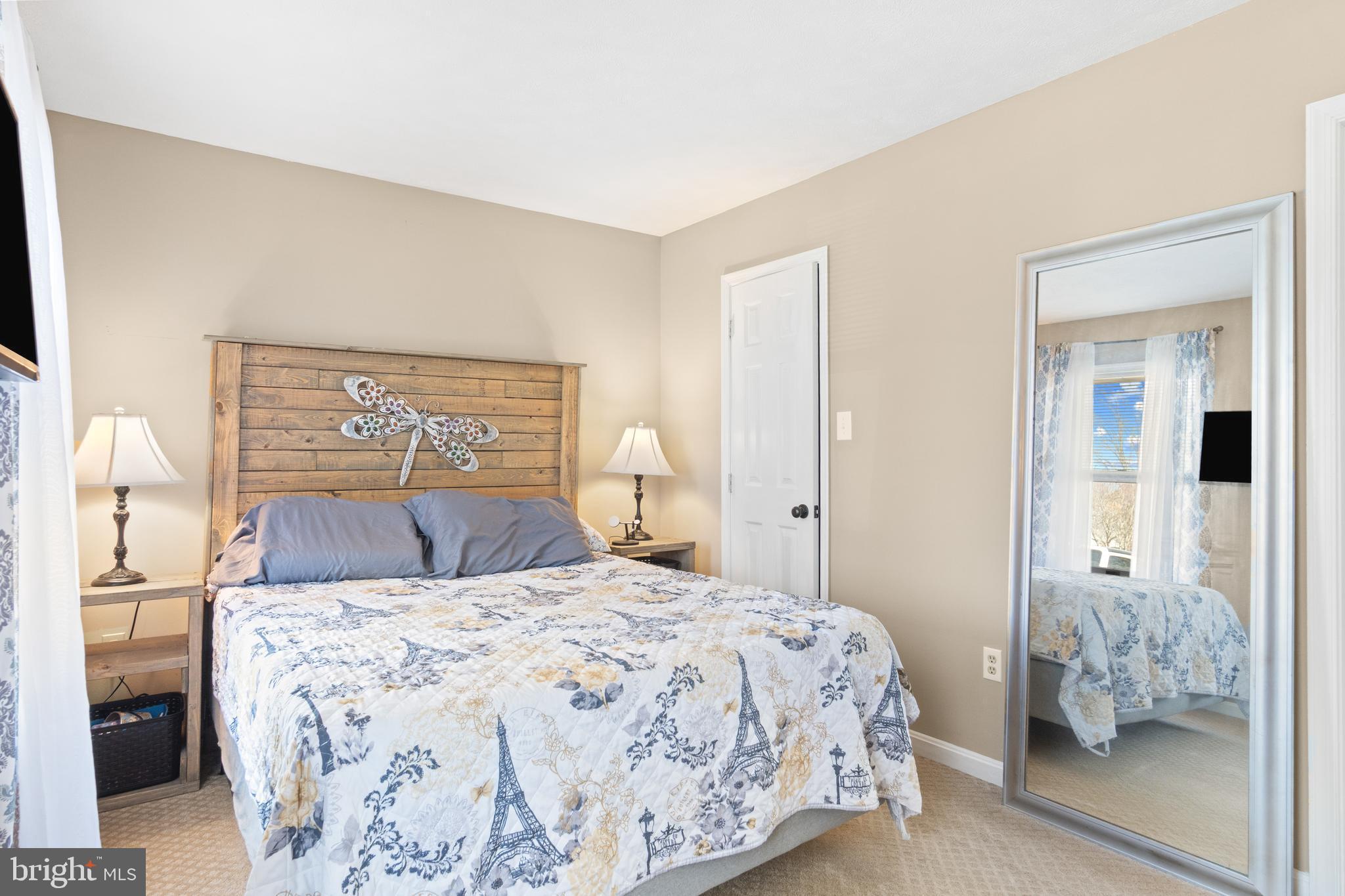 1636 Harrier Lane Culpeper, VA 22701 - Photo 8 of 19 a bedroom with a large bed and a chandelier