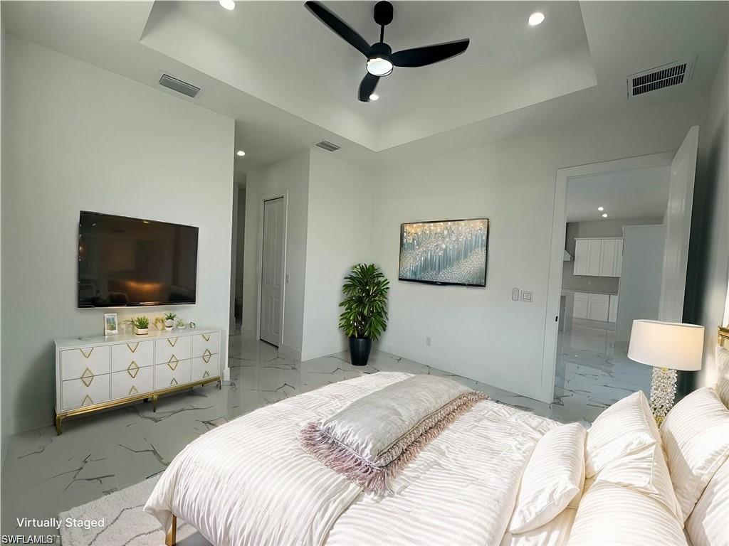 3510 15th Street Southwest Lehigh Acres, FL 33976 - Photo 13 of 50 Bedroom featuring marble finish floor, a tray ceiling, visible vents, and baseboards