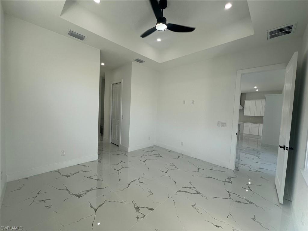 3510 15th Street Southwest Lehigh Acres, FL 33976 - Photo 33 of 50 Empty room featuring a tray ceiling and ceiling fan