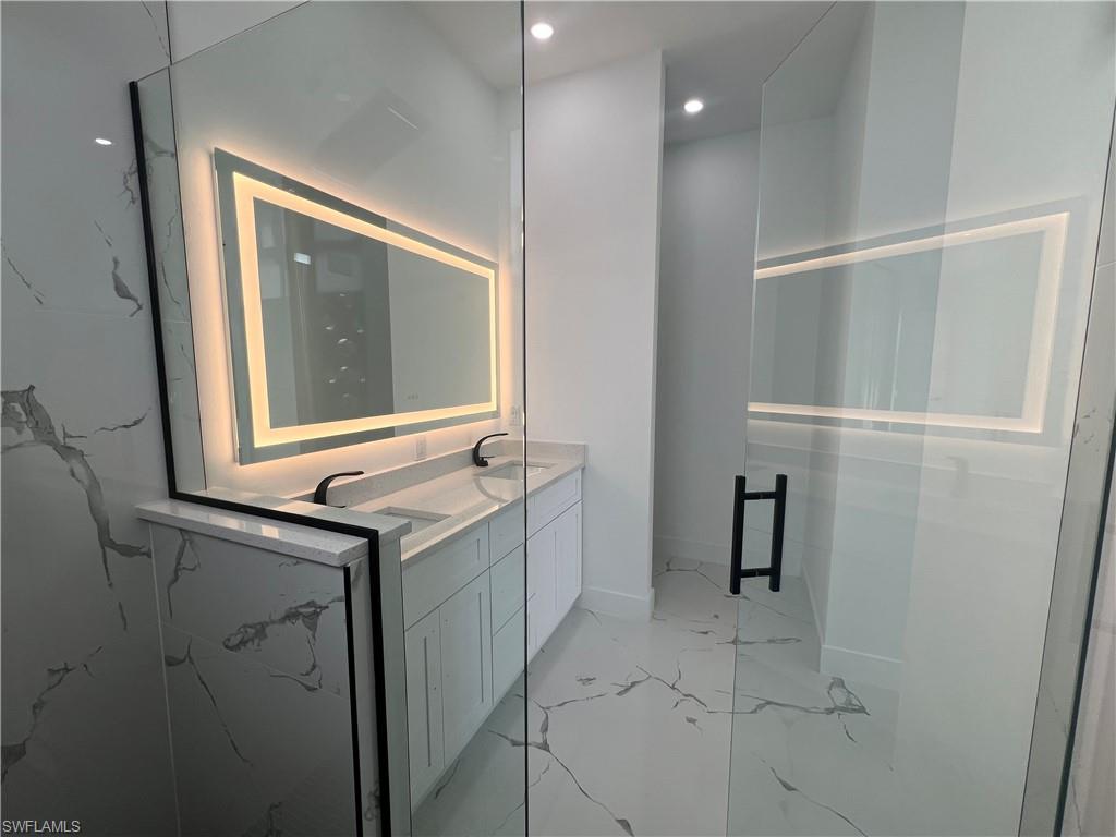 3510 15th Street Southwest Lehigh Acres, FL 33976 - Photo 34 of 50 Bathroom with vanity and a shower with shower door