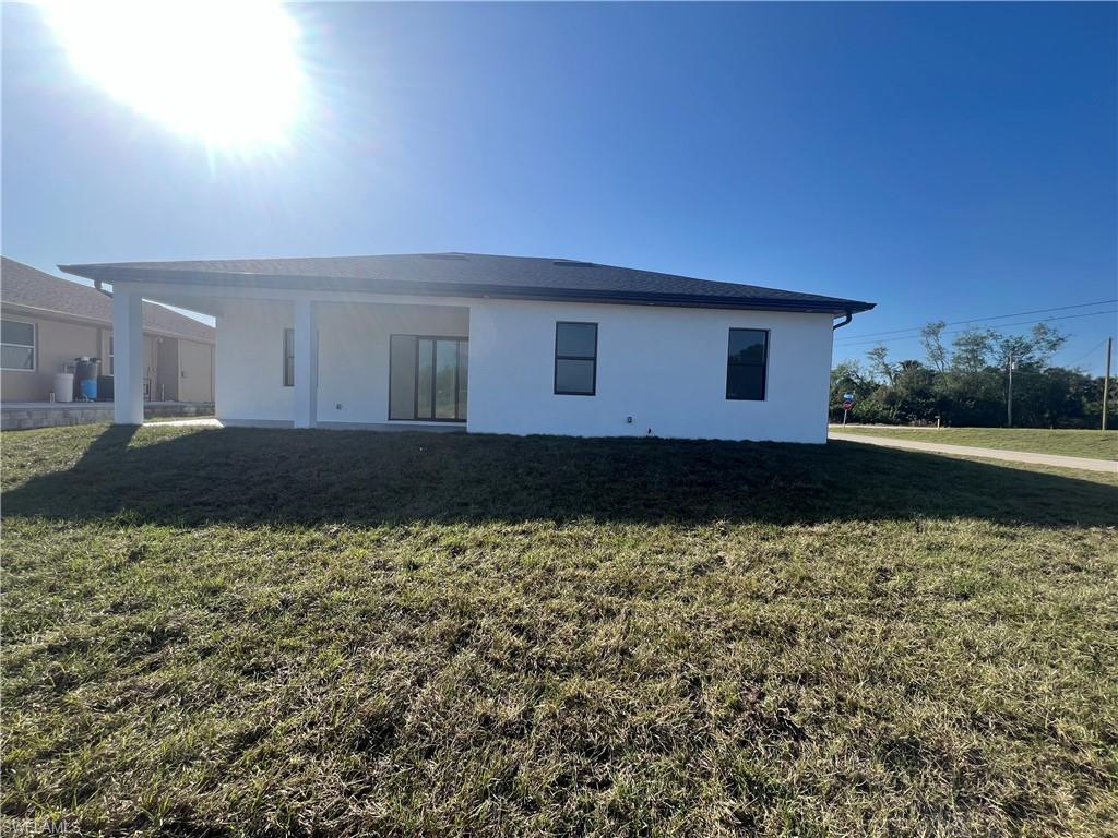3510 15th Street Southwest Lehigh Acres, FL 33976 - Photo 38 of 50 Back of house with a yard