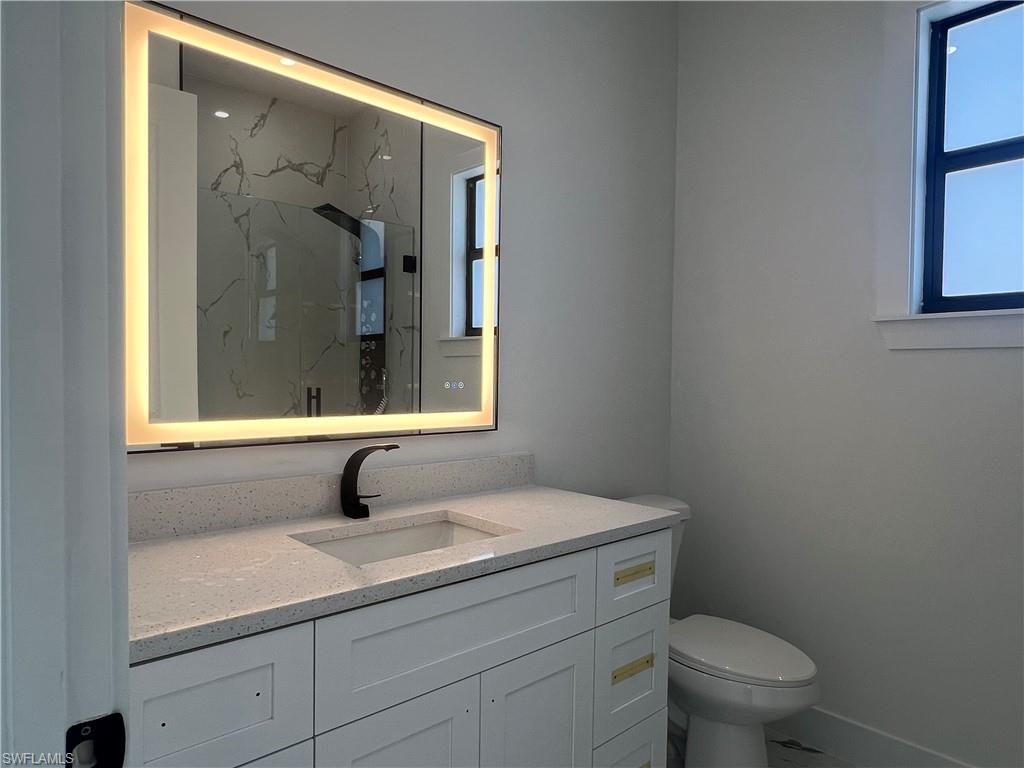 3510 15th Street Southwest Lehigh Acres, FL 33976 - Photo 47 of 50 Bathroom with a shower, vanity, and toilet