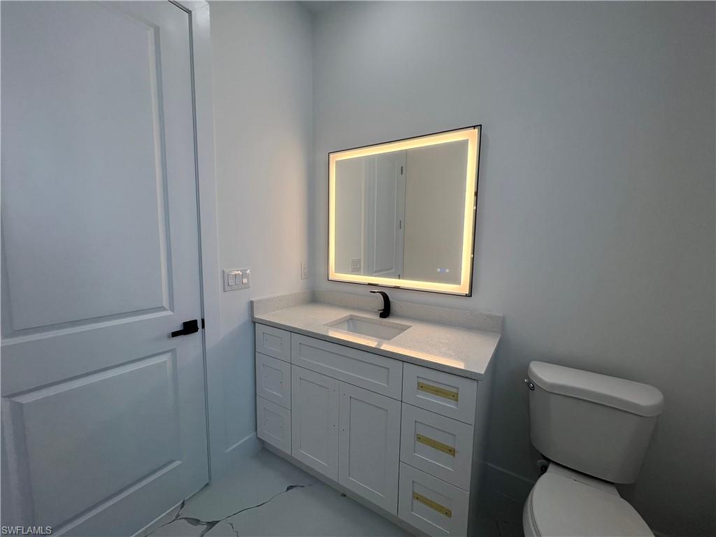 3510 15th Street Southwest Lehigh Acres, FL 33976 - Photo 50 of 50 Bathroom with vanity and toilet