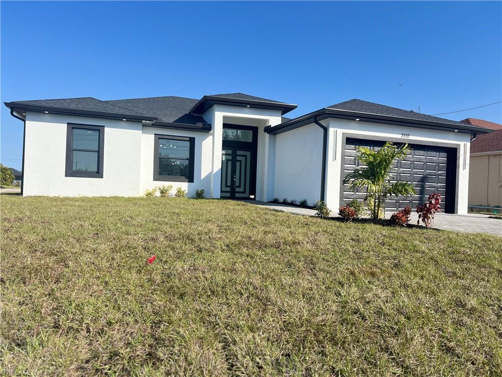 3510 15th Street Southwest Lehigh Acres, FL 33976 - Photo 5 of 50 Prairie-style home with a garage and a front lawn