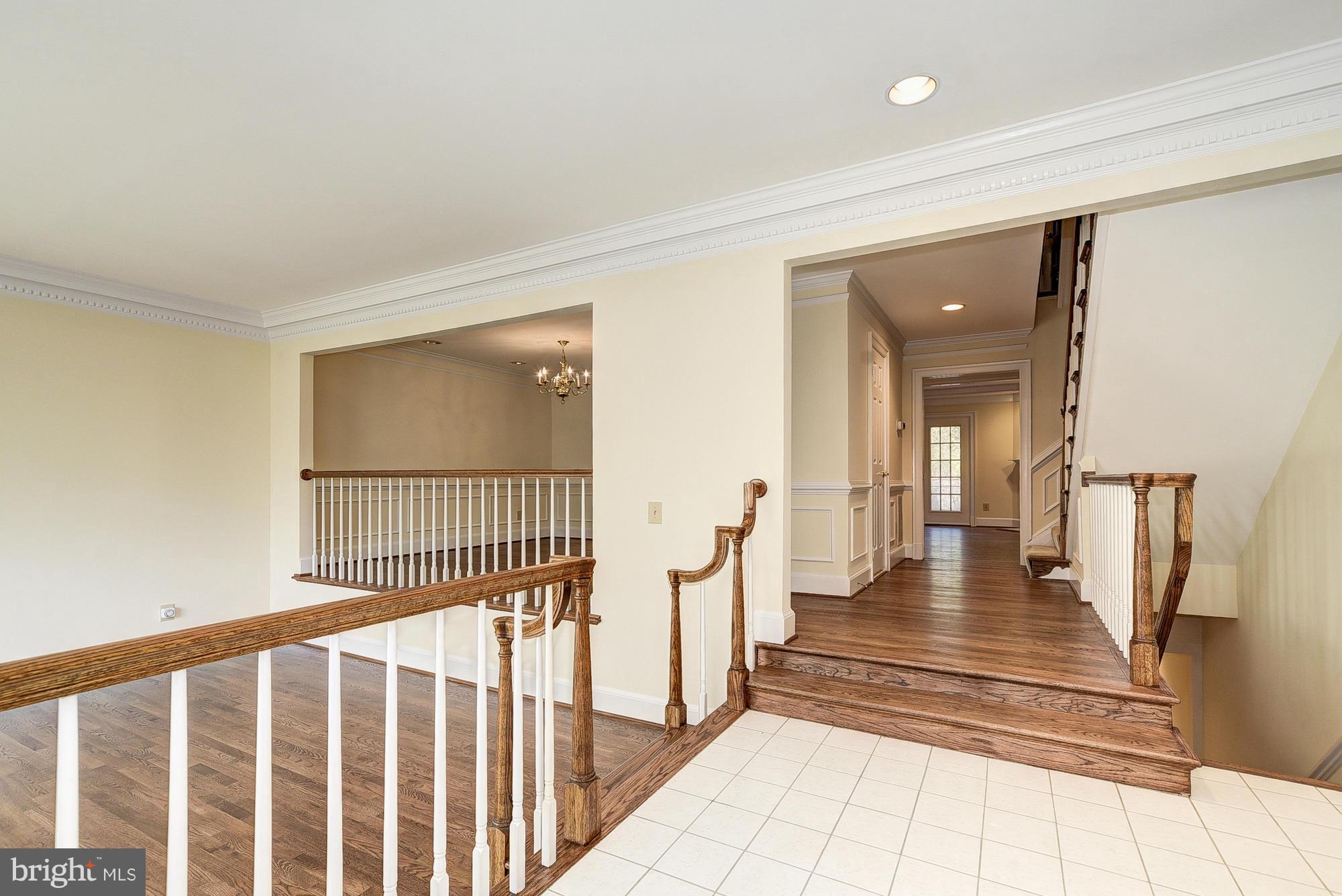 8023 Rising Ridge Road Bethesda, MD 20817 - Photo 2 of 30 a view of staircase with lots of frames and rug