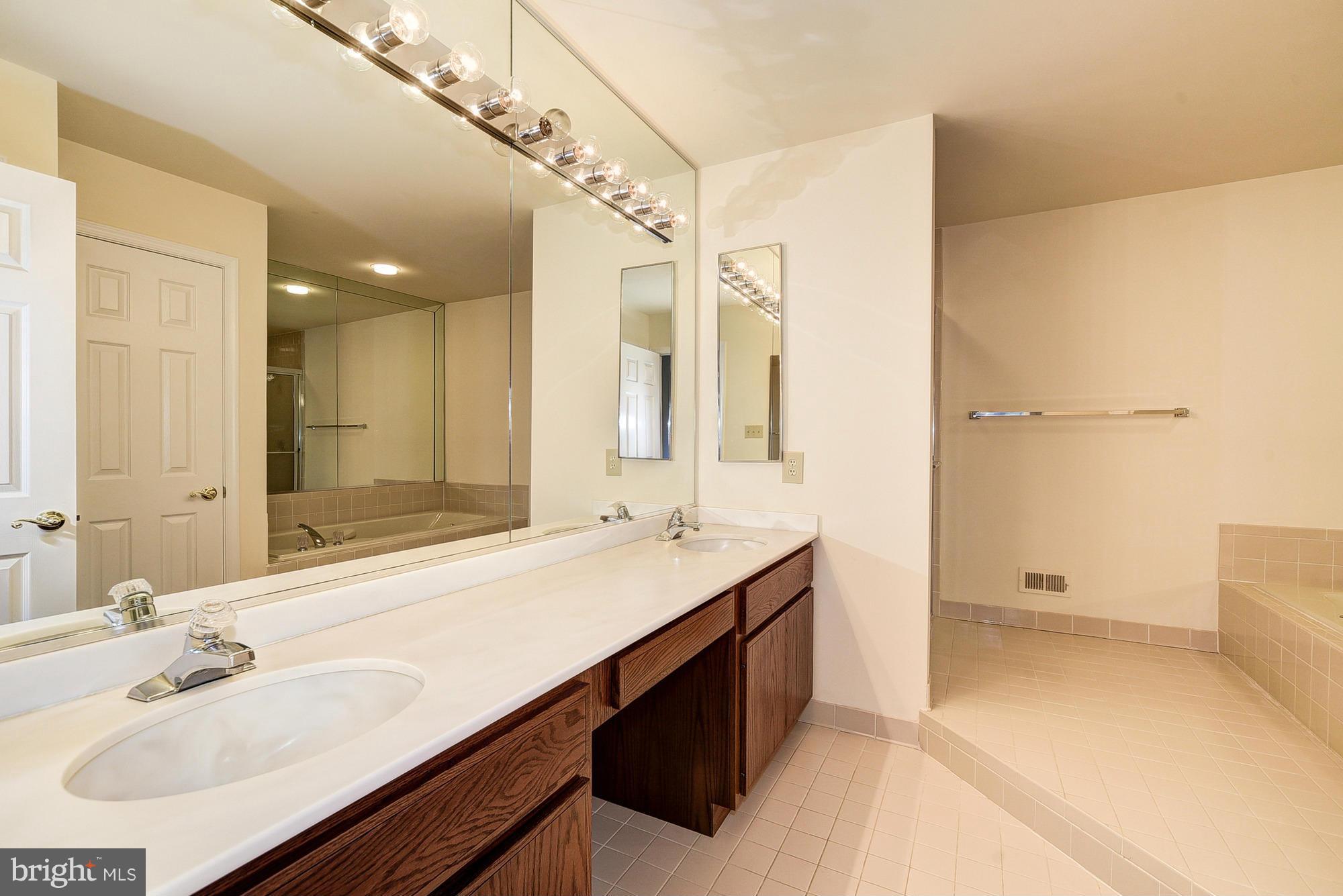 8023 Rising Ridge Road Bethesda, MD 20817 - Photo 15 of 30 a bathroom with a sink double vanity and a mirror