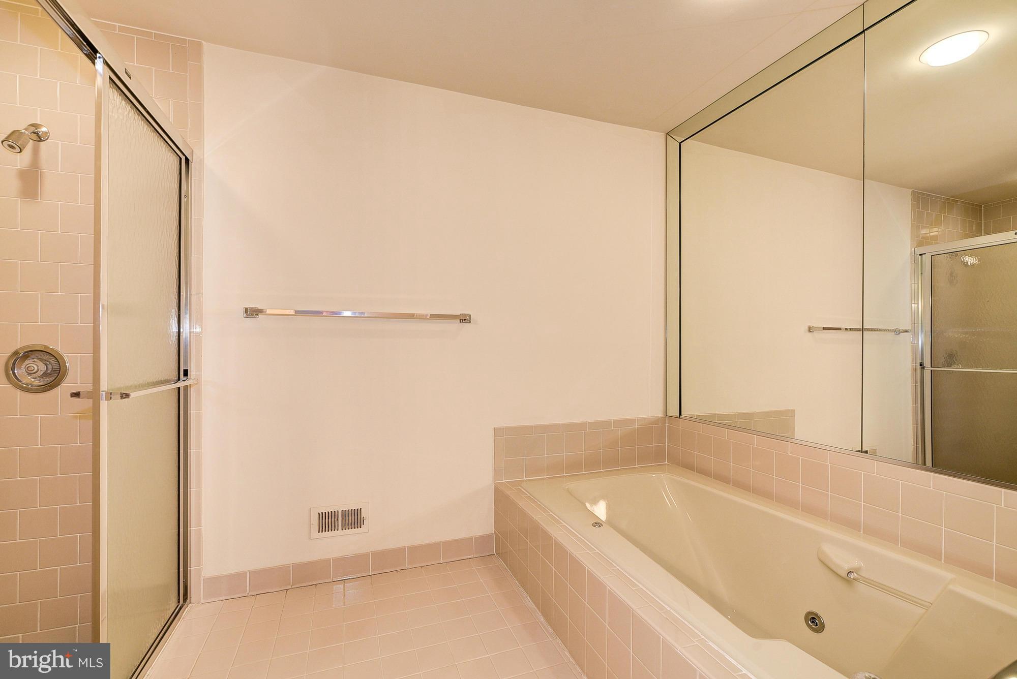 8023 Rising Ridge Road Bethesda, MD 20817 - Photo 16 of 30 a bathroom with a tub shower and a sink